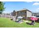 Backyard featuring a well-maintained lawn, patio seating and grilling area at 5884 Grande River Rd, Atlanta, GA 30349