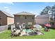 Large backyard featuring a well-manicured lawn, patio seating area, and a grill at 5884 Grande River Rd, Atlanta, GA 30349