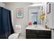 Bathroom with a navy curtain, white vanity, and a mirror at 5884 Grande River Rd, Atlanta, GA 30349