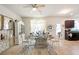 Bright dining area featuring a decorative glass table, zebra rug, and adjacent kitchen at 5884 Grande River Rd, Atlanta, GA 30349