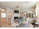 Open dining area with a fireplace, television, and zebra rug, adjacent to the living space at 5884 Grande River Rd, Atlanta, GA 30349