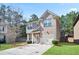 Lovely two-story home featuring a combination of brick and siding, a well-kept lawn, and a driveway at 5884 Grande River Rd, Atlanta, GA 30349