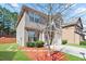 Side view of the home showing the well-manicured lawn and brick and siding exterior at 5884 Grande River Rd, Atlanta, GA 30349