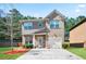 Charming two-story home with a well-maintained front yard and a combination brick and siding exterior at 5884 Grande River Rd, Atlanta, GA 30349