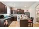 Compact kitchen with dark cabinetry, light tile flooring, and a breakfast bar seating area at 5884 Grande River Rd, Atlanta, GA 30349