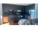 Modern kitchen features sleek dark cabinets, stainless steel appliances, and dark backsplash at 361 17Th Nw St # 1717, Atlanta, GA 30363