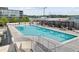 Exterior view of the community swimming pool, with sun loungers and pergola covered seating areas at 361 17Th Nw St # 1717, Atlanta, GA 30363