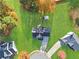 Aerial view of the home shows lush green yard, mature trees, driveway and neighboring houses at 12 Windcrest, Covington, GA 30016