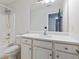 Clean bathroom with a shower-tub combo, vanity, and large mirror at 12 Windcrest, Covington, GA 30016