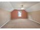 Spacious bedroom with carpet flooring, a unique vaulted ceiling, and window at 12 Windcrest, Covington, GA 30016