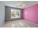 Charming bedroom featuring a ceiling fan, neutral and pink accent walls and natural light at 12 Windcrest, Covington, GA 30016
