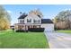 Charming two-story home with a manicured front yard, a covered front porch, and attached garage at 12 Windcrest, Covington, GA 30016