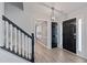 Welcoming foyer featuring modern lighting and staircase with contrasting banister at 12 Windcrest, Covington, GA 30016