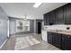 Eat-in kitchen with gray walls, black cabinets, and stainless-steel appliances at 12 Windcrest, Covington, GA 30016
