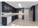 Functional kitchen with black cabinets and modern white appliances at 12 Windcrest, Covington, GA 30016