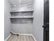 Functional laundry room with shelving and gray tile accent wall at 12 Windcrest, Covington, GA 30016