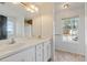 Bright main bathroom with a double sink vanity, large mirror and window at 12 Windcrest, Covington, GA 30016