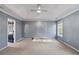 Bright and airy main bedroom features a tray ceiling and a large window at 12 Windcrest, Covington, GA 30016