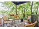 Outdoor balcony features seating and lush green tree views at 198 Ponce De Leon Ne Ave # 5D, Atlanta, GA 30308