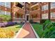 Lush landscaping leads to the front entrance of this charming red brick apartment building at 198 Ponce De Leon Ne Ave # 5D, Atlanta, GA 30308