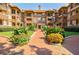 Beautiful courtyard entrance to a red brick apartment building with mature landscaping at 198 Ponce De Leon Ne Ave # 5D, Atlanta, GA 30308