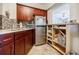 Bright kitchen features tile backsplash, stainless refrigerator and custom shelving at 198 Ponce De Leon Ne Ave # 5D, Atlanta, GA 30308