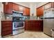 This beautiful kitchen features stainless steel appliances, dark wood cabinets, and tile backsplash at 198 Ponce De Leon Ne Ave # 5D, Atlanta, GA 30308