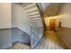 Bright staircase features a modern railing and clean lines leading up to a private wooden door at 198 Ponce De Leon Ne Ave # 5D, Atlanta, GA 30308