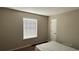 Simple bedroom featuring a window, door, and laminate wood flooring at 2820 Skye Ter, Duluth, GA 30096