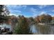 Scenic lake view with a dock and colorful autumn trees against a blue sky at 2820 Skye Ter, Duluth, GA 30096