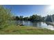 Picturesque lake view with a wooden dock, framed by green trees and a grassy shoreline at 2820 Skye Ter, Duluth, GA 30096