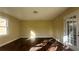 Spacious living room with laminate floors, window, and an exterior door at 2820 Skye Ter, Duluth, GA 30096