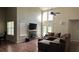 Spacious living room with high ceilings, a fireplace, and a comfortable brown sectional couch at 2820 Skye Ter, Duluth, GA 30096