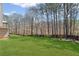 Large backyard provides ample space for outdoor activities, framed by mature trees and a fence at 330 Meadowcrest Cir, Canton, GA 30115