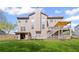 Backyard featuring multi-level wooden deck, green lawn, and house with a gray siding at 330 Meadowcrest Cir, Canton, GA 30115
