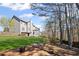 Large green backyard featuring a wooden fence, gray house, trees and room for entertaining at 330 Meadowcrest Cir, Canton, GA 30115