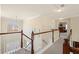 Upstairs hallway featuring hardwood railings and an arched window at 330 Meadowcrest Cir, Canton, GA 30115