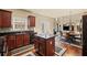 Modern kitchen with dark cabinetry, central island, and open to dining area at 330 Meadowcrest Cir, Canton, GA 30115