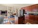 Modern kitchen with an island, stainless steel appliances, granite countertops, and dark wood cabinets at 330 Meadowcrest Cir, Canton, GA 30115