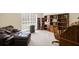 Cozy office space featuring a large window, hardwood furniture, a leather couch, and a rolling office chair at 330 Meadowcrest Cir, Canton, GA 30115