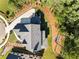 Aerial view of a private residence showing the roof, driveway, landscaping and back fire pit at 6055 Tattnall Overlook, Acworth, GA 30101