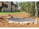 Stone steps lead to a rock feature in the backyard at 6055 Tattnall Overlook, Acworth, GA 30101