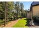 This backyard features a lush lawn, mature trees, and tasteful landscaping, enhancing the property's natural beauty at 6055 Tattnall Overlook, Acworth, GA 30101