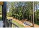 View of a backyard, showing a treed landscape with a leveled gravel portion at 6055 Tattnall Overlook, Acworth, GA 30101