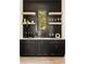 Close up of stylish bar area with dark cabinets, floating shelves, white countertop and view to outdoors at 6055 Tattnall Overlook, Acworth, GA 30101