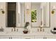 Bright bathroom featuring double vanity, decorative mirrors and fixtures, with natural light, and clean white countertops at 6055 Tattnall Overlook, Acworth, GA 30101