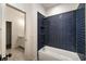 Modern bathroom with blue tiled shower and stylish fixtures at 6055 Tattnall Overlook, Acworth, GA 30101