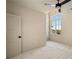 Bright bedroom featuring a ceiling fan, neutral walls, and large window offering plenty of natural light at 6055 Tattnall Overlook, Acworth, GA 30101