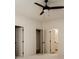 Neutral bedroom with multiple doors, soft carpeting, and a ceiling fan for a comfortable living space at 6055 Tattnall Overlook, Acworth, GA 30101
