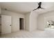 Large bedroom with walkout door, neutral walls, plush carpeting, and ceiling fan at 6055 Tattnall Overlook, Acworth, GA 30101